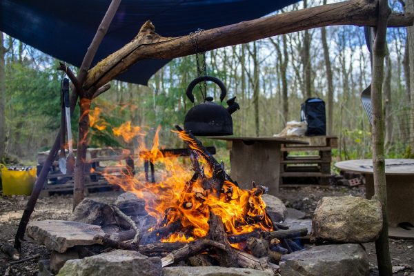 Camping kettle heating over an outdoor fire
