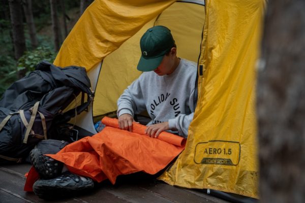 camping tent on cliff during golden hour