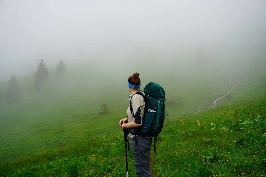a man with a backpack walking through a field