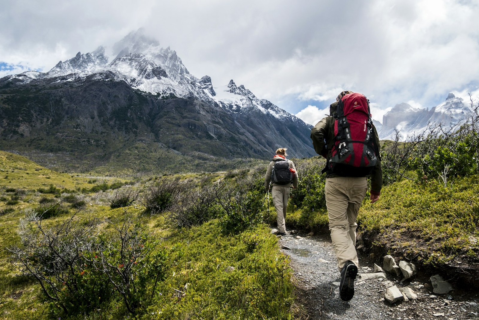 Hiker preparing a backpack for a multi-day outdoor trip