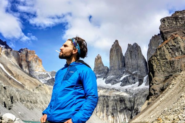 a man standing in front of a mountain range